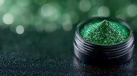 Vibrant emerald green cosmetic glitter powder in black jar against dark background with bokeh lights, macro photography for makeup and nail art applications.