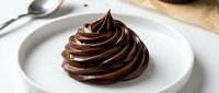 Rich chocolate frosting swirl on white plate, smooth creamy texture for baking dessert decoration, pastry chef culinary presentation ready for cake topping.