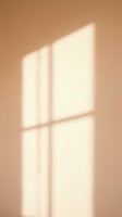 Window light shadow on warm beige wall, creating geometric patterns for interior design, architecture, and minimalist backgrounds.