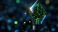 Glowing green brain inside light bulb with bokeh background, representing artificial intelligence, innovation and creative thinking in technology concept.