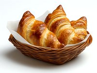 Fresh baked golden croissants served in woven basket with white napkin, showing flaky layered texture and glossy butter-brushed surface. For bakery promotion.