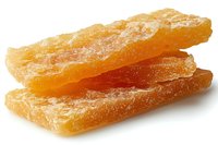 Crystallized ginger slices with translucent amber color and sugar coating on white background, macro food photography showing natural texture and sweetness.
