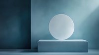 Minimalist composition with white circle floating above rectangular pedestal against turquoise wall, dramatic lighting creates modern aesthetic for product display.