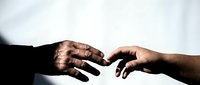 Two hands reaching toward each other in dramatic lighting, symbolizing connection, unity, and human touch against soft blurred background for emotional concepts.