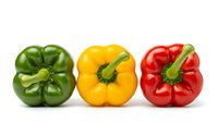 Three colorful bell peppers in green, yellow and red arranged in row on white background. Fresh organic vegetables isolated for cooking and healthy eating.