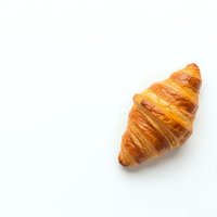 Fresh golden croissant isolated on white background for bakery menu design and culinary projects.