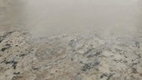 Granite countertop surface with natural stone texture and speckled pattern for kitchen and bathroom interior design applications.