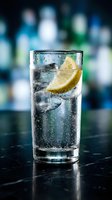Tall glass filled with sparkling water, ice cubes, and fresh lemon slice on dark surface with blurred bar background. Refreshing beverage for restaurants, bars, hospitality, and food photography.
