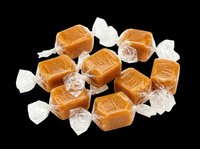 Caramel candies wrapped in clear cellophane, isolated on transparent background. Ready for design use on packaging, posters, print-on-demand products, and digital graphics.