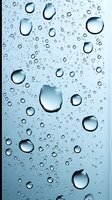 Clear water drops on glass surface with soft blue background creating natural abstract pattern. Macro photography showing surface tension and reflection.