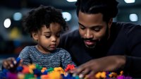 African American father and young son playing together with colorful building blocks, sharing quality family time in educational activity. Learning through play.