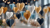 Paper heart decorations hanging on strings create romantic atmosphere with warm bokeh lights in background for wedding or Valentine's Day events.