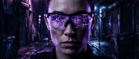 Man wearing futuristic glasses with digital grid overlay in cyberpunk neon environment. Suitable for tech, AI, and digital transformation concepts.