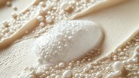 Luxurious skincare cream with water droplets and bubbles on smooth surface creating spa-like moisturizing treatment for beauty and wellness routines.
