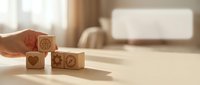 Hand placing wooden blocks with healthcare symbols on bright surface representing medical care concepts and wellness services.