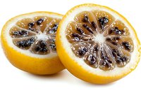 Fresh cut yellow citrus fruit with black seeds and translucent flesh on white background, macro photography showing detailed texture and juicy segments.