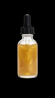 Golden liquid serum in glass dropper bottle with black cap, isolated on transparent background. Ready for cosmetics, skincare, beauty product design, packaging mockups, print-on-demand and e-commerce use.