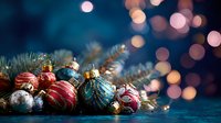 Festive Christmas ornaments and spruce branches against dark blue background with soft bokeh lights creating magical holiday atmosphere.