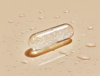 Transparent medical capsule with glitter filling on beige background with water drops. Pharmaceutical and wellness concept for supplement advertising.