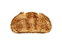 Freshly baked whole wheat bread roll with golden-brown crust, isolated on white background. Perfect for bakery, food, and culinary design projects.