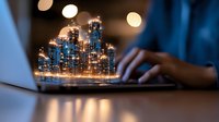 Glowing holographic city skyline projection above laptop keyboard while person works in dark room with bokeh lights, futuristic technology concept.