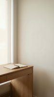 Minimalist wooden desk with open book in neutral corner space for home office interior design and workspace decoration.