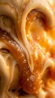 Creamy peanut butter swirl with glossy texture and water droplets, ideal for food advertising, packaging design, and culinary content.