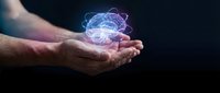 Male hands holding glowing digital brain with neural networks on dark background representing artificial intelligence and machine learning technology.