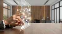 Businessman hand touching holographic brain with glowing neural networks and digital connections in modern office environment for AI technology concepts.