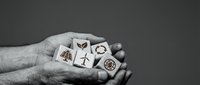 Caucasian male hand holding wooden blocks with environmental and sustainability icons including leaf, wind turbine, and recycling symbol against neutral background for eco-friendly concepts.