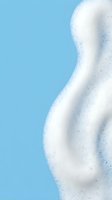 White foamy soap bubbles on bright blue background for cleaning and hygiene concepts in advertising and product design.