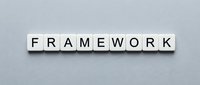 Framework word spelled with wooden letter tiles on gray background for business strategy and organizational structure concepts.