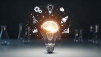 Glowing light bulb with innovation icons floating above representing creative business ideas, brainstorming, and entrepreneurial thinking for startup success.