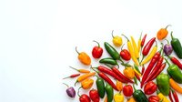 Colorful hot peppers and chili varieties arranged on white background, isolated for culinary, cooking, and food design projects.