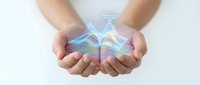 Hands cupping glowing holographic energy with rainbow light effects for spiritual healing and digital technology concepts.