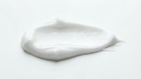 White cosmetic cream or lotion smear isolated on white background, ready for skincare product packaging design and beauty advertising use.