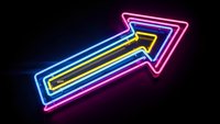Bright neon arrow sign glowing with colorful electric lights on dark background for business advertising and directional signage applications.