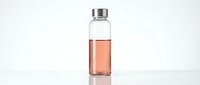 Clear glass bottle with stainless steel cap containing pink or coral-colored liquid, isolated on white background, suitable for product mockups, cosmetics, beverages, or wellness packaging design.
