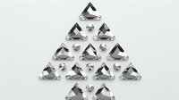 Sparkling clear triangular crystals arranged in Christmas tree shape formation on light background, luxury festive concept for holiday season designs.