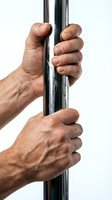 Strong male hands gripping chrome pole showing determination and strength for fitness training and exercise motivation isolated on white background.