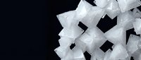 White crystalline salt mineral formation with cubic geometric structure on dark background for scientific and educational materials.