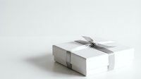 Elegant white gift box with silver ribbon and bow on clean background for special occasions and celebrations.