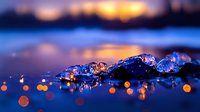 Melting ice crystals on dark blue surface with golden bokeh lights at sunset, dramatic macro photography with shallow depth of field and reflections.