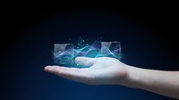 Caucasian hand holding glowing digital data visualization with network connections and analytics charts on dark background for technology and business concepts.
