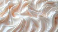 Flowing cream silk fabric with elegant waves and soft folds creating luxurious texture for fashion and interior design backgrounds.
