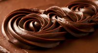 Rich chocolate frosting swirls with glossy texture perfect for cake decoration, baking projects, dessert photography and culinary marketing materials.