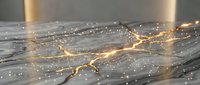 Marble surface with glowing golden cracks and sparkling light particles, kintsugi-inspired luxury texture for interior design and backgrounds.