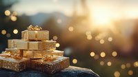 Festive golden gift boxes stacked in pyramid shape against blurred bokeh sunset background, creating magical holiday atmosphere with warm glowing lights.