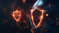 Glowing orange and blue shield icons with sparks and particles on dark background, representing digital security and cyber protection concept.