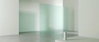 Young woman with light skin tone, wearing professional business attire, standing in modern minimalist interior space with frosted glass partitions and polished concrete flooring for corporate office design projects.